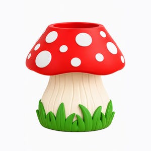 Può includere: Un contenitore a forma di fungo con un cappello rosso brillante e macchie circolari bianche. La base è color crema con scanalature verticali ed è circondata da un anello di fili d'erba verde brillante. La parte superiore è aperta e cava.