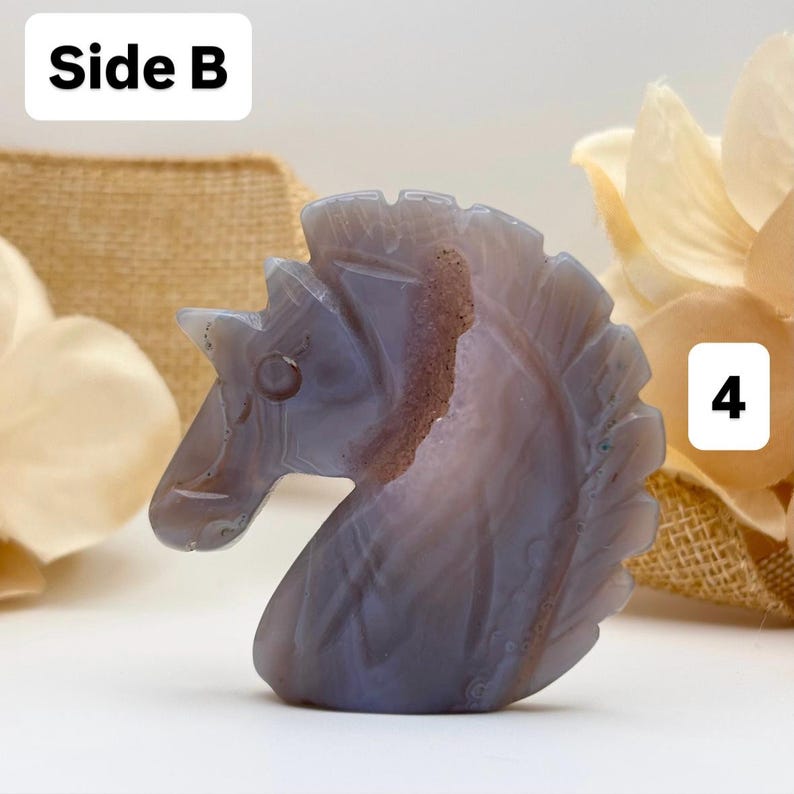 May include: A carved stone sculpture of a horse's head. The sculpture is primarily blue-grey with brown and white veining. The word "Side B" is in a white box in the upper left corner, and the number "4" is in a white box in the lower right corner.