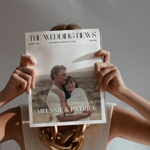 May include: A person holding a newspaper titled "THE WEDDING NEWS" with the headline "MELANIE & PATRICK ARE GETTING MARRIED TODAY." The newspaper is dated Saturday, August 15, 2024, in Rome, Italy, at 2:00 PM. The person is wearing a white top and a gold chain.