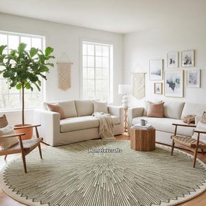 May include: A living room scene featuring a circular rug with a geometric pattern in green and cream. Two cream sofas, wooden chairs, and a potted plant are arranged around the rug. The room has white walls and large windows.