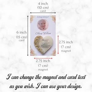 May include: A white card with a gold heart-shaped magnet attached. The card measures 15 cm by 10 cm and features a photo of a woman and the text "In loving memory of Olivia Wilson". The magnet measures 7 cm in diameter and has the text "In loving memory of Olivia Wilson 1958-2024".
