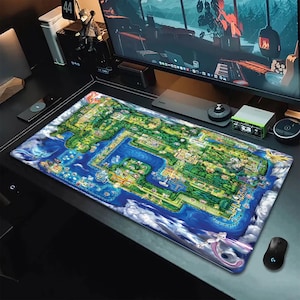 May include: A rectangular desk mat featuring a detailed, colorful map illustration of a fictional island landscape with lush green forests, winding paths, blue water bodies, and various mythical creatures positioned around the perimeter.