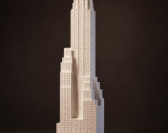 May include: A white architectural model of a skyscraper featuring a stepped, tiered design with a central tower and multiple rectangular sections. The structure displays a grid of small, recessed windows across its entire facade, creating a detailed, textured surface.