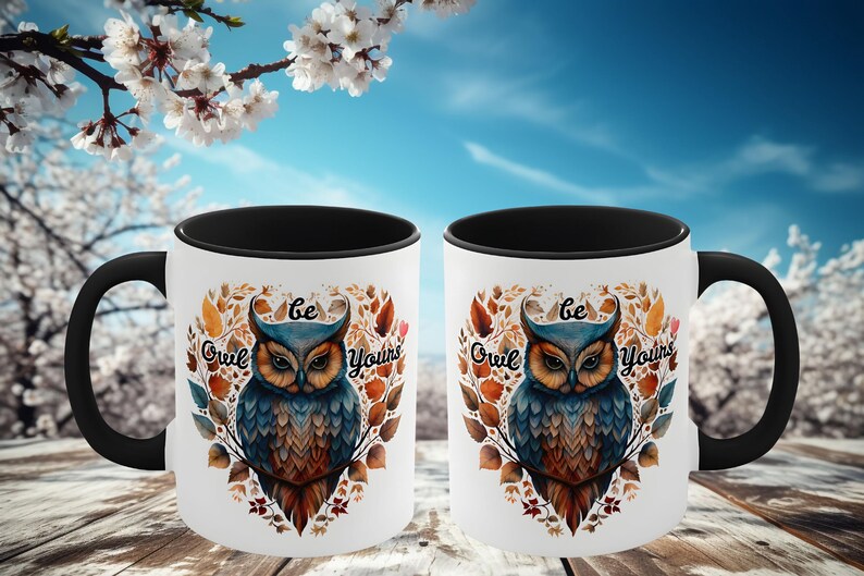 May include: Two black and white coffee mugs with a black handle. The mugs have a white background with a colorful owl illustration and the text "Be Owl Yourselves".