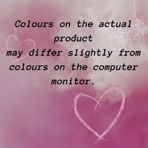 May include: A pink background with the text "Colours on the actual product may differ slightly from colours on the computer monitor." Two pink heart outlines and a white floral design are also present.