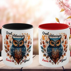 May include: Two white ceramic mugs with owl illustrations. One mug has a black handle and interior, the other has a red handle and interior. Both mugs feature the text "Owl Always Love You!" in a heart-shaped design.