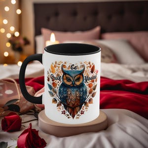 May include: White ceramic mug with a black rim and handle. The mug features a colorful illustration of an owl with the text "Be Owl Yours" in a heart-shaped frame.