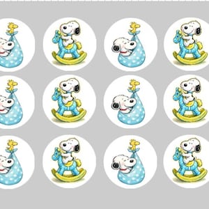 May include: A sheet of twelve circular stickers featuring alternating illustrations of Snoopy inside a blue polka-dot bundle with Woodstock on top, and Snoopy riding a blue rocking horse with yellow rockers, all set against a light gray background.