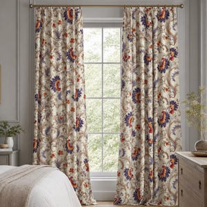 May include: A pair of floor-length curtains featuring a cream background with a repeating floral pattern in shades of deep purple, burnt orange, and muted green. The curtains hang from a simple bronze-toned metal rod with rings at the top.