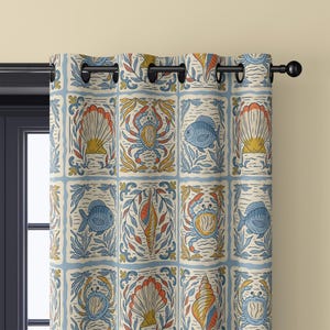 May include: A patterned curtain featuring a repeating design of marine life. The design includes blue fish, crabs, and seashells in a grid pattern, with a cream background and blue borders. The curtain is hung on a black rod.