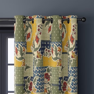 May include: Floral patchwork curtain panel with a rod pocket. The curtain features a mix of colors including olive green, mustard yellow, navy blue, and cream. The design includes floral and geometric patterns. The curtain is hanging on a black rod.
