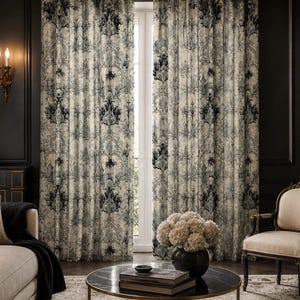 May include: Floor-to-ceiling curtains featuring a detailed black and cream damask pattern. The fabric hangs in vertical folds, covering a window area. The intricate design consists of symmetrical floral and scroll motifs repeated throughout.