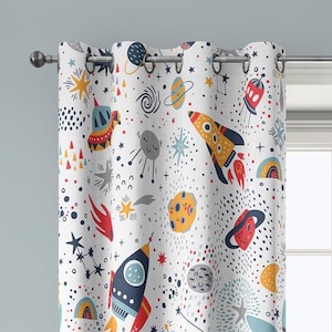 May include: White space-themed curtain panel featuring colorful rockets, planets, stars, and other celestial elements. The design includes red, yellow, blue, and orange accents, creating a playful and educational aesthetic. The curtain has metal grommets for hanging.