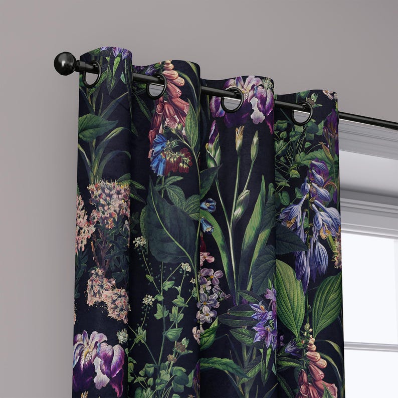 May include: Dark navy blue floral curtains with a botanical print featuring purple, pink, and blue flowers, and green leaves. The curtains are hung on a black rod with black grommets. The design is a detailed, artistic rendering of various flowers and foliage.