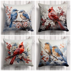 May include: Four decorative throw pillows with watercolor bird designs. Two pillows feature blue birds, and two showcase red cardinals. Each pillow has a white background with floral and wintery accents, perfect for home decor.