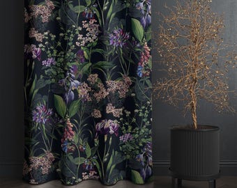 May include: Dark floral curtain with a botanical print featuring purple, pink, and green flowers on a black background. The curtain is next to a black planter with a dried plant.