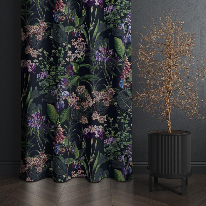 May include: Dark floral curtain with a botanical print featuring purple, pink, and green flowers on a black background. The curtain is next to a black planter with a dried plant.