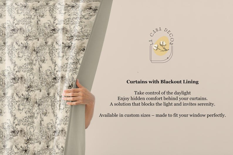May include: Cream-colored curtains with a black and gray floral pattern are partially open, revealing a neutral wall. The text on the wall reads "Curtains with Blackout Lining". The curtains are designed to block light and are available in custom sizes.