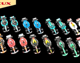 May include: A collection of miniature race cars in various colors, including pink, blue, orange, red, and green. Each car has a detailed design with black wheels and a sleek body. The image includes the text "3D JEUX" in the top left corner.