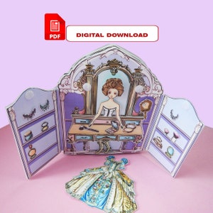 K&ouml;nnte beinhalten: Ein ausdruckbares Papierpuppen-Set mit einer Puppe in einem wei&szlig;en Kleid und einem Schminktisch mit Spiegel, Make-up und Schmuck. Die Puppe hat ein blaues und gelbes Kleid, das an die Puppe angesteckt werden kann.