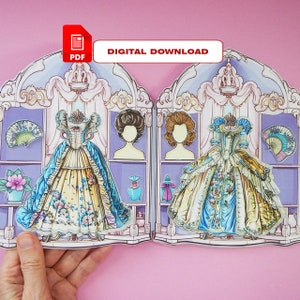 K&ouml;nnte beinhalten: Ein druckbares Papierpuppen-Set mit einem Kleid im Vintage-Stil mit einem blauen und gelben Blumenmuster. Die Puppe hat zwei verschiedene Frisuren zur Auswahl und wird mit Accessoires wie einem F&auml;cher und einer Parf&uuml;mflasche geliefert. Das Papierpuppen-Set ist ein digitaler Download im PDF-Format.