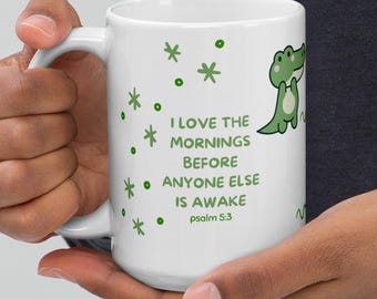 May include: White ceramic mug with a green cartoon alligator and the text "I LOVE THE MORNINGS BEFORE ANYONE ELSE IS AWAKE psalm 5:3". The mug has green star and dot designs.