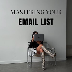 May include: A woman sits in a white chair with a laptop in front of her face. The laptop screen is displaying a white apple logo. The woman is wearing black clothing and snake-skin boots. The text "MASTERING YOUR EMAIL LIST" is displayed on a white wall behind the woman.