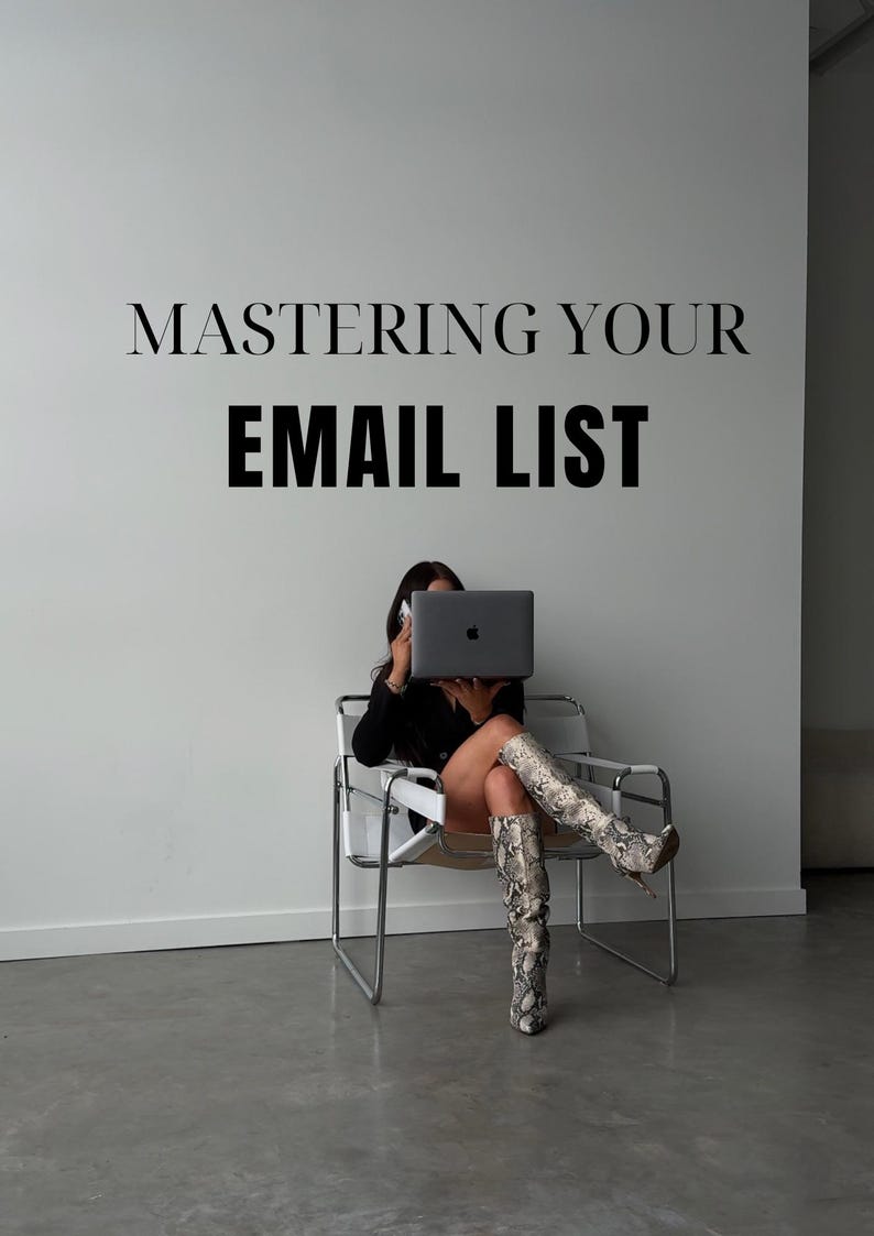 May include: A woman sits in a white chair with a laptop in front of her face. The laptop screen is displaying a white apple logo. The woman is wearing black clothing and snake-skin boots. The text "MASTERING YOUR EMAIL LIST" is displayed on a white wall behind the woman.