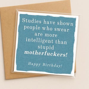 May include: A square greeting card with a blue textured background and white text that reads: Studies have shown people who swear are more intelligent than stupid motherfuckers! Happy Birthday! The card is placed on top of a brown envelope.