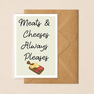 May include: A rectangular greeting card with a light cream background featuring the black text Meats & Cheeses Always Pleases. Below the text is a small illustration of a wooden cutting board with two yellow cheese wedges and a red sausage.