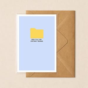 May include: A light blue greeting card featuring a yellow computer folder icon and the black pixelated text "OPEN FILE FOR BIRTHDAY MESSAGE" centered below it, accompanied by a plain brown envelope positioned behind the card.