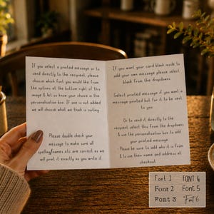 May include: A white greeting card with black printed instructions regarding personalization options, font choices, and shipping details. The card includes a small chart in the bottom right corner displaying six distinct font styles labeled Font 1 through Font 6.