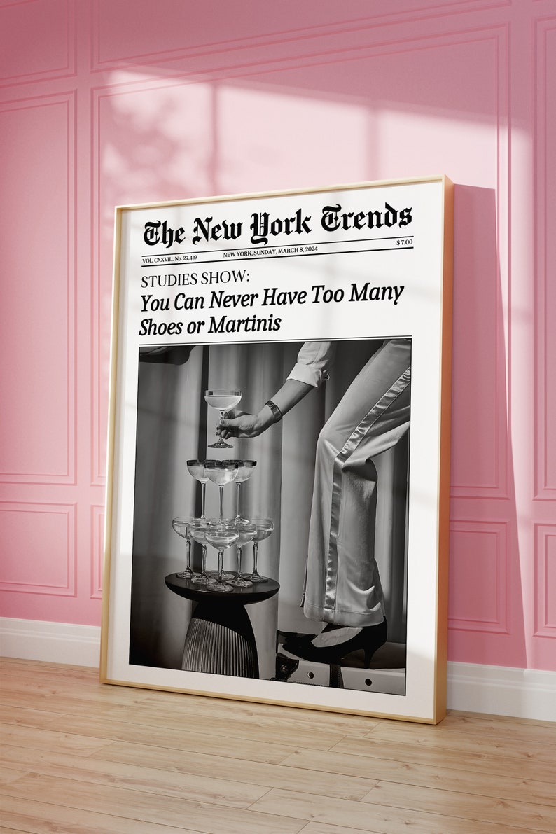 May include: A black and white photo of a person holding a martini glass. The photo is framed and has the headline "The New York Trends" and the text "STUDIES SHOW: You Can Never Have Too Many Shoes or Martinis".