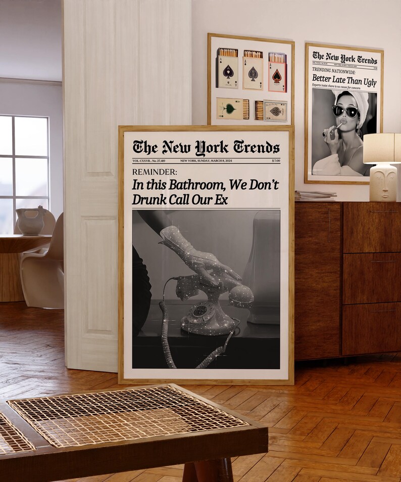 May include: A black and white newspaper print with the headline "The New York Trends" and the text "REMINDER: In this Bathroom, We Don't Drunk Call Our Ex". The image shows a hand reaching for a vintage rotary phone.