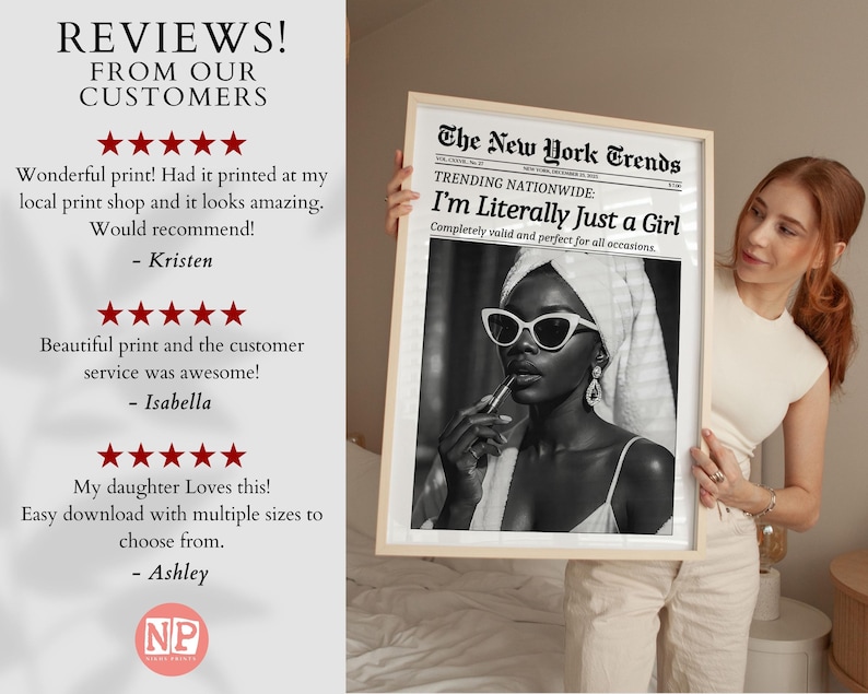 May include: A framed black and white print featuring a woman wearing sunglasses and applying lipstick. The print is designed to look like a newspaper, with the headline "I'm Literally Just a Girl."