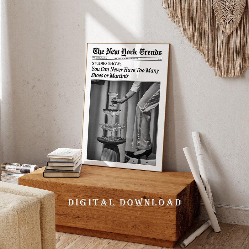 May include: Black and white photo of a woman's leg and hand reaching for a glass of champagne. The photo is framed and has the text "The New York Trends" and "STUDIES SHOW: You Can Never Have Too Many Shoes or Martinis" at the top. The text "DIGITAL DOWNLOAD" is at the bottom of the image.