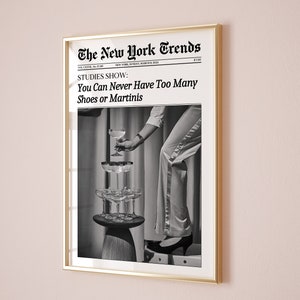 May include: A black and white photo of a woman wearing a dress and heels, holding a martini glass. The photo is framed in a gold frame and has the text "The New York Trends" at the top. The text "STUDIES SHOW: You Can Never Have Too Many Shoes or Martinis" is below the photo.