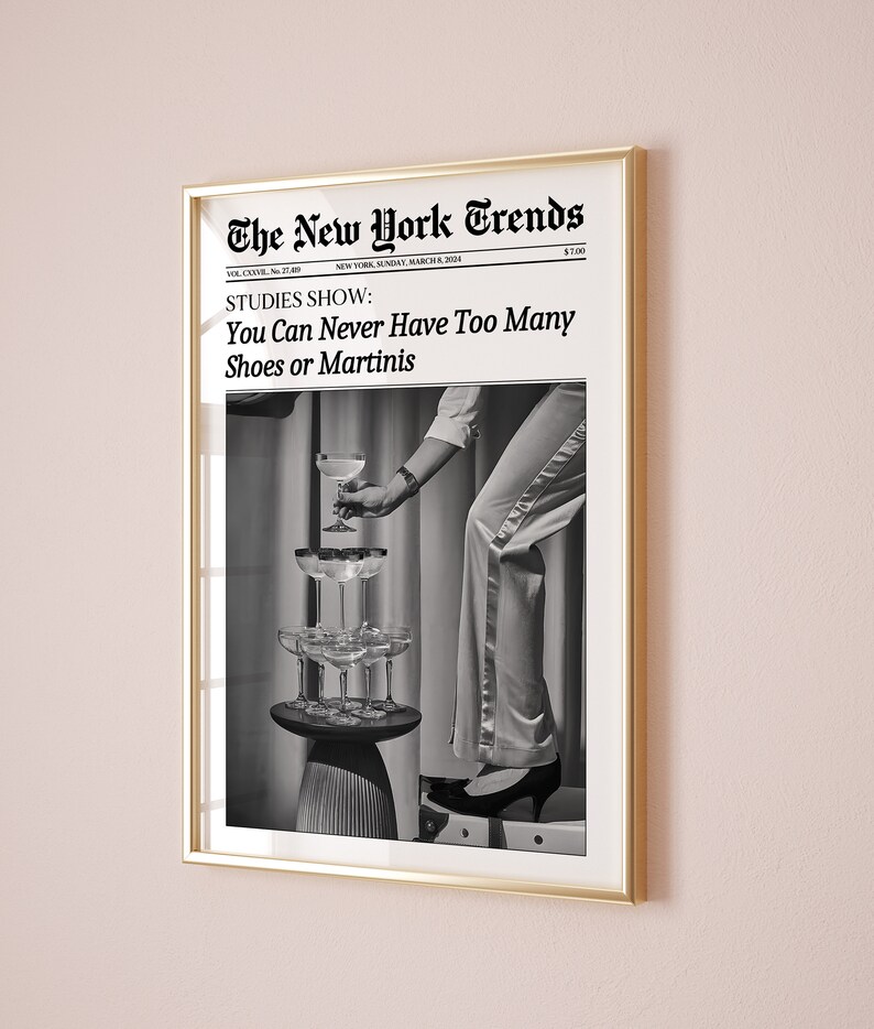 May include: A black and white photo of a woman wearing a dress and heels, holding a martini glass. The photo is framed in a gold frame and has the text "The New York Trends" at the top. The text "STUDIES SHOW: You Can Never Have Too Many Shoes or Martinis" is below the photo.