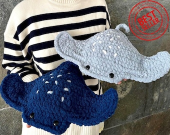 May include: Two crocheted stingray plushies. One is blue with white spots and the other is gray with white spots. Both have black eyes and a stitched smile.