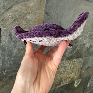 May include: A crocheted purple and white stingray plush toy.