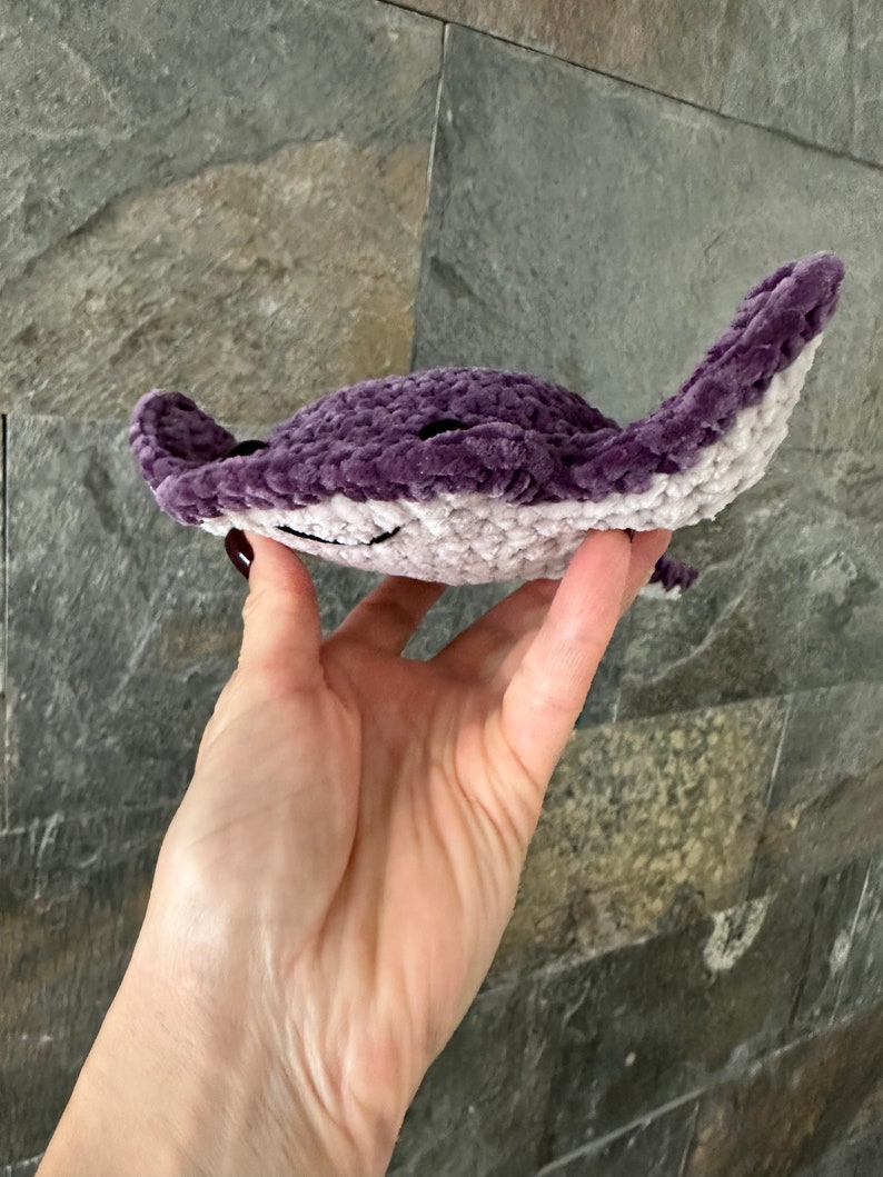 May include: A crocheted purple and white stingray plush toy.