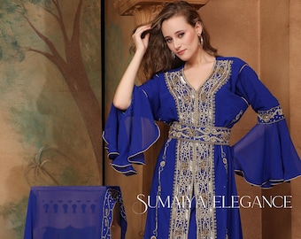 May include: A royal blue kaftan with gold embroidery and a matching belt. The kaftan has long sleeves with a bell shape and a deep V-neckline. The fabric is sheer and flowing. The kaftan is adorned with intricate beading and sequins.