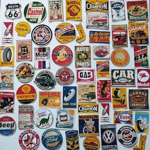 May include: A collection of assorted vintage-style automotive stickers featuring various logos, signs, and illustrations related to motor oil, tires, spark plugs, and classic car brands, displayed in a grid-like arrangement on a white background.