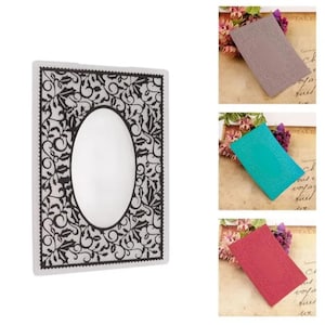 May include: A rectangular embossing folder featuring a central oval frame surrounded by a detailed border of holly leaves and swirling vines. The design is presented in a black and white version, alongside three solid-coloured versions in mauve, teal, and red.