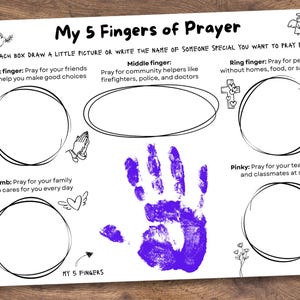 May include: A white activity sheet titled My 5 Fingers of Prayer with black text and line art illustrations of a dove, angel, cross, heart, and flowers. It features five empty circles for drawings and a central purple handprint with the text My 5 Fingers.