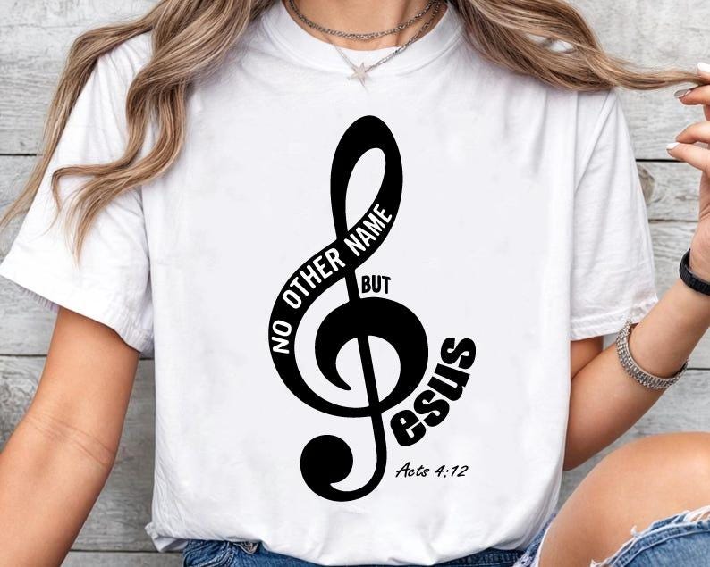 May include: White t-shirt featuring a black treble clef design with the words "NO OTHER NAME BUT Jesus" and the Bible verse "Acts 4:12". The design is centered on the front of the shirt.