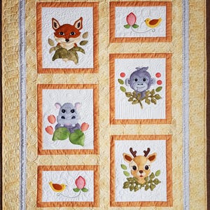 May include: A white quilt with a yellow border and orange inner border. The quilt has five squares with embroidered images of a fox, a bird, a monkey, a hippopotamus, and a deer. Each square has a white background and is surrounded by a yellow border.