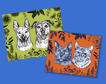 May include: Two art prints featuring pen and ink illustrations of dogs and cats. One print has two dogs on a green background with floral accents. The other print has two cats on an orange background with floral accents. The prints are on a blue background.