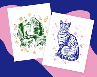 May include: Two printable art prints featuring illustrations of a dog and a cat. The dog is green and surrounded by gold flowers and leaves. The cat is blue and surrounded by pink stars. Both prints are on white paper.