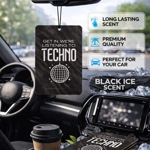 May include: Black car air freshener with the text "GET IN, WE'RE LISTENING TO TECHNO" and a globe graphic. The air freshener is black with a black ice scent. The image also shows a car interior.